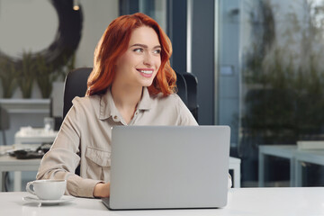 Poster - Happy woman working with laptop at white desk in office