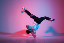 Young Guy Dancer Is Dancing Break In Neon Lighting, Male Acrobat Is Doing Trick And Dance Exercise