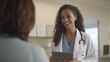 © Phoophinyo - Attractive female doctor giving advice to patient Medicine, health and people concept, female doctor with tablet computer talking to smiling female patient at hospital. generative ai