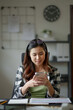 © mojo_cp - Working woman Asian Architects designer using smartphone.