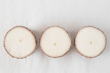 Wall Mural - Close-up of a manioc root against a white background