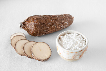 Wall Mural - Close-up of a cassava root on a white background with tapioca pearls