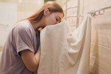 A Woman Wipes Herself With A Towel In The Bathroom After Washing.