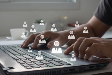 Concept of target audience. Businessman presses a button on a laptop computer with Target audience icons. Targeting, Marketing, HR and recruitment. Business, technology and internet concept.