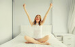 © rohappy - Healthy sleep, happy cheerful young woman having fun or waking up on soft comfortable bed in white bedroom