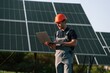 © standret - Modern laptop is in hands. Man is doing operating and maintenance in solar power plant
