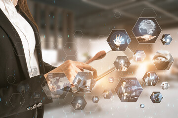 Poster - Connecting businesspeople, technology, metaverse and video conference concept. Close up of female hands using tablet with creative hexagonal images on blurry office interior background.
