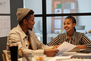 Poster - Young smiling businesswoman looking at male colleague during discussion of working points and making decisions about key tasks and goals