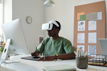Aufkleber - Young graphic designer in extended reality headset using stylus and touchpad while creating new computer games by workplace