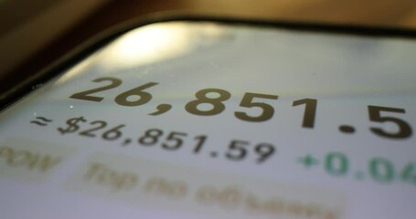 Stock exchange cryptocurrency price quotes and numbers on smartphone screen. Analysis of financial risks of stockbrokers using a mobile application
