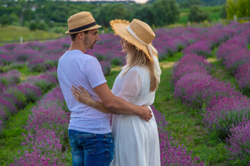 Wall Mural - loving couple in lavender field. Selective focus.