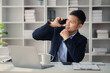 © kamiphotos - Man working in office and talking on the phone, he is young businessman, modern business management, start-up company run by young people, modern entrepreneur with new ideas. to be a business leader.