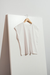 Wall Mural - White women's t-shirt mockup template on wooden hanger