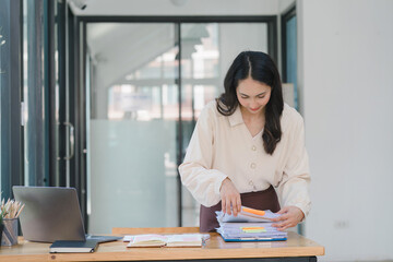 Young Indian Accountant Woman in casuals working on financial analysis documents with a tense expression in the office. Business finance and accounting concepts.