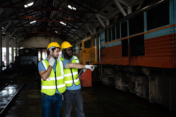 Wall Mural - Railway engineering team Wear your safety gear and helmet under inspection under the wheels and controls to ensure the safety of the train. train maintenance.