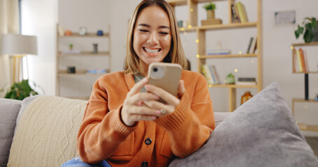 Wall Mural - Woman, phone and video call on home sofa with internet connection to wave hand for hello while talking. Asian female happy, relax and online for a conversation on social media or communication app