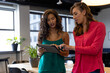 © WavebreakMediaMicro - Diverse female colleagues in discussion using tablet in office