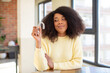 © kues1 - pretty afro black woman smiling and looking with a happy confident expression. dental retainer concept