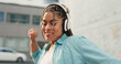 © Azee/peopleimages.com - Woman, dancing and listening to music in the city with headphones for audio streaming in the outdoors. Happy female dancer enjoying 5G connection with headset to listen for sound track in urban town