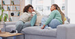 © Azee/peopleimages.com - Friends, women and talking on sofa, bonding in home living room and communication. Girls, friendship relax and smile of happy females chatting, speaking or discussion, sharing story or conversation.