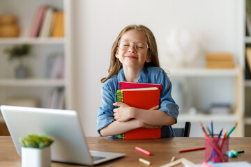 Wall Mural - Girl doing homework or online education.