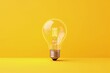 © Kaleb - Light bulb isolated on yellow background, idea and creativity concept, Generative AI