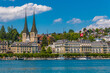 Lovely view of the right lake shore of Lucerne with the Church of St. Leodegar (German: Hofkirche St. Leodegar) on a nice sunny day with a blue sky. It is the parish church of Lucerne.