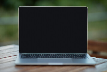 Aufkleber - Laptop computer with blank black screen standing on desk outdoors