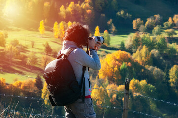 Young man traveler looking and photographing beautiful autumn in Turkey, Travel lifestyle concept.