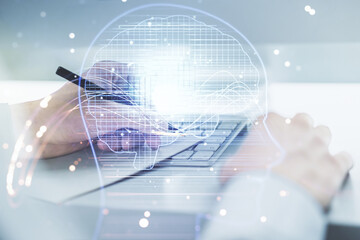 Poster - Double exposure of creative artificial Intelligence symbol with hand writing in notebook on background with laptop. Neural networks and machine learning concept