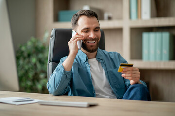 Poster - Smiling Businessman Making Mobile Payments, Holding Credit Card And Talking On Cellphone
