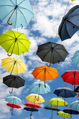 Colorful umbrellas hanging above a street