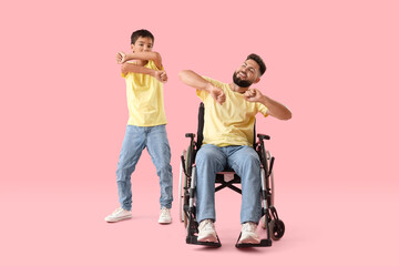 Poster - Little boy and his father in wheelchair dancing on pink background