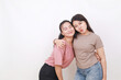 © ArvStd - Two young beautiful smiling asian female on white background. Friendship concept