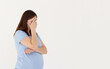 Embarrassed annoyed adult pregnant woman hiding face bend head down, facepalm, smirk irritated, not looking friend acting weird, feel humiliated uncomfortable, standing white background