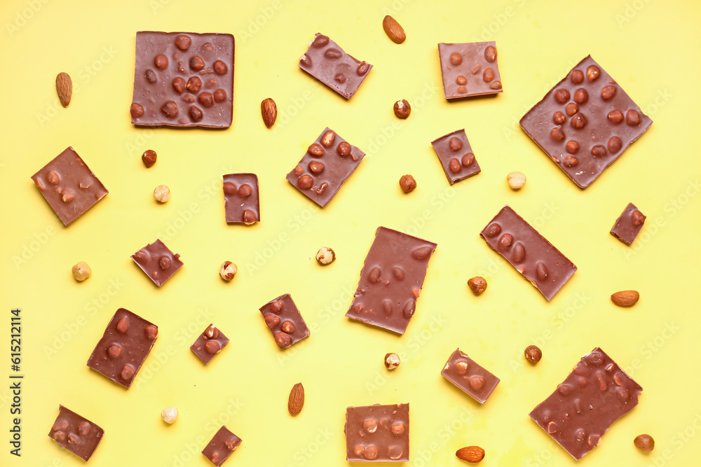 Sweet tasty chocolate with nuts on  yellow background