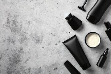 Wall Mural - black tubes and bottles with men's cosmetics on stone table. flat lay, top view.