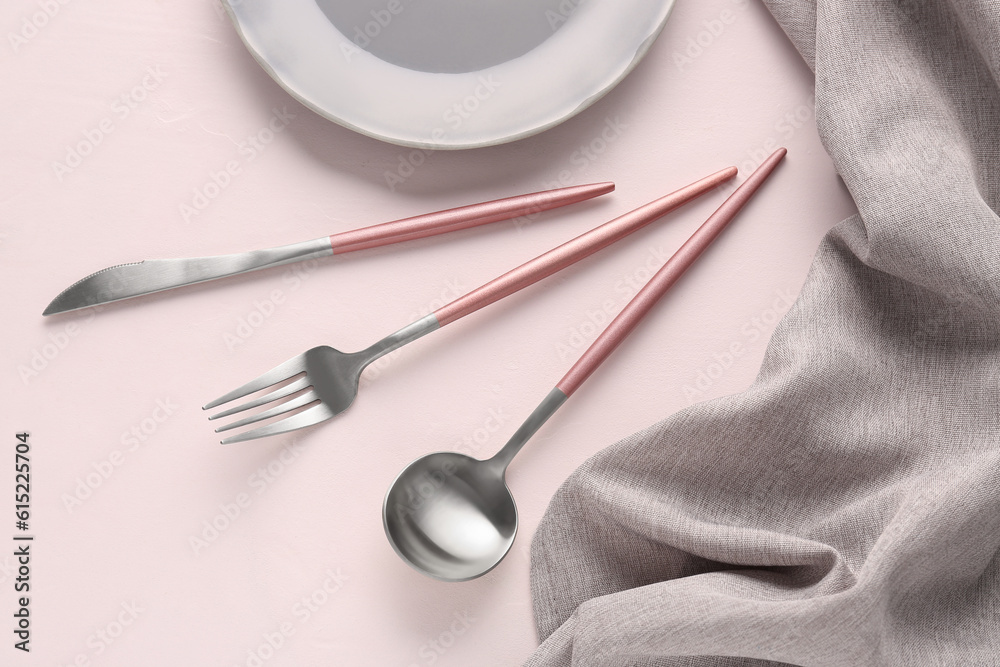 Plate with stainless steel cutlery on white background