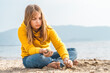© velirina - Lonely beautiful sad girl teenager sits thoughtfully on sand sea beach. Dreams,anxiety,worries about future,school friends, parents. Teen bullying, psychological problems in adolescent puberty period