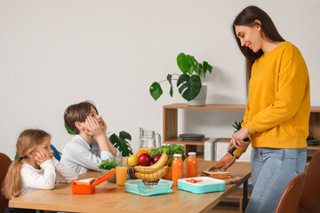 Sticker - Mother preparing school lunch for her little children in kitchen