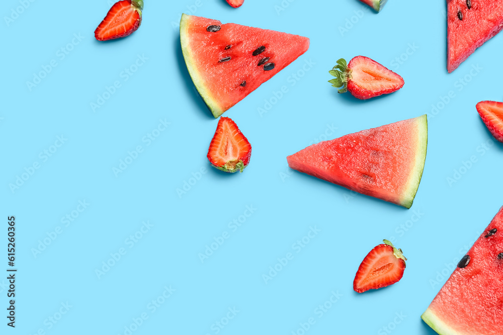 Pieces of fresh watermelon and strawberries on blue background