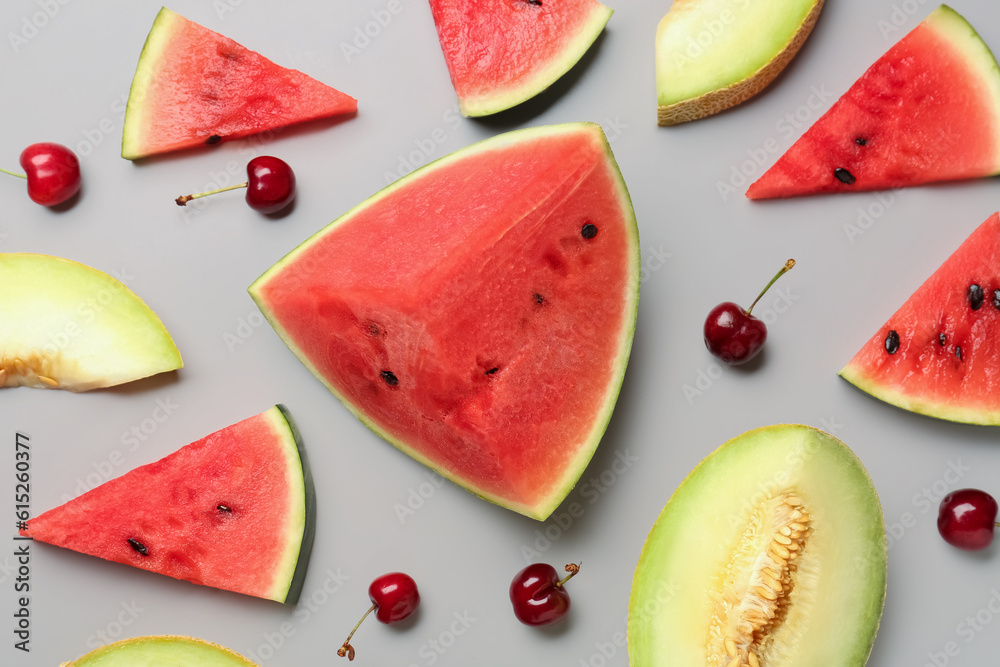 Pieces of fresh watermelon and different berries on grey background