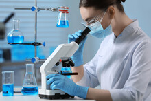 Young Scientist Working With Microscope In Laboratory