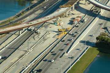 Wall Mural - Industrial roadworks in Miami, Florida. Wide american highway junction under construction. Development of interstate transportation system for rapid transit for long distance travelling