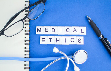 stethoscope, pen and glasses with the word Medical Ethics. concept of medical ethics