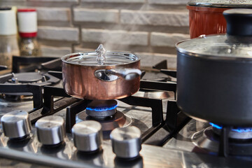 Poster - Pots with cooking food in the kitchen on gas stove