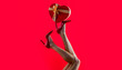 © Yevhen - Beautiful legs woman. Shapely legs, a girl in shoes high-heeled. Female legs wearing high heels. Gift in heart shape on the background. Gift tied with ribbon. Valentine's day