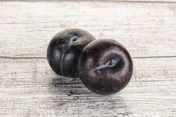 Two ripe sweet black plums