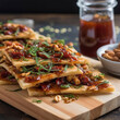 oriental flatbread cut into pieces with spices and herbs on a wooden table close-up