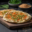 oriental flatbread with spices, sesame seeds and herbs on a wooden table, close-up